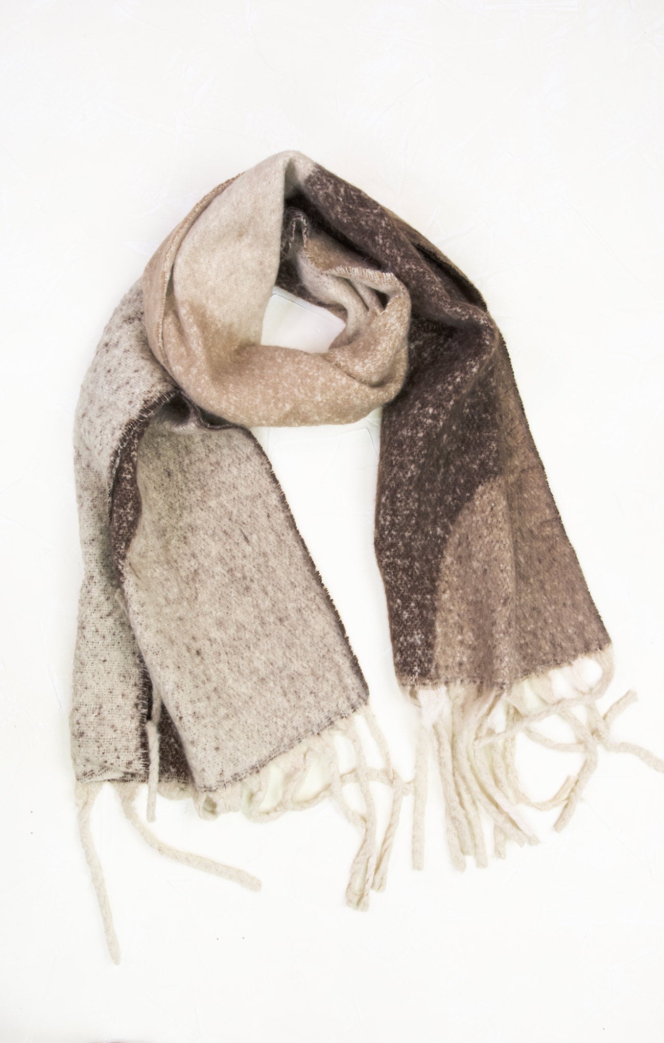 Woven scarf with fringes in beige and brown on a white background