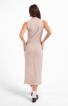 Woman wearing a beige sleeveless dress on a white background