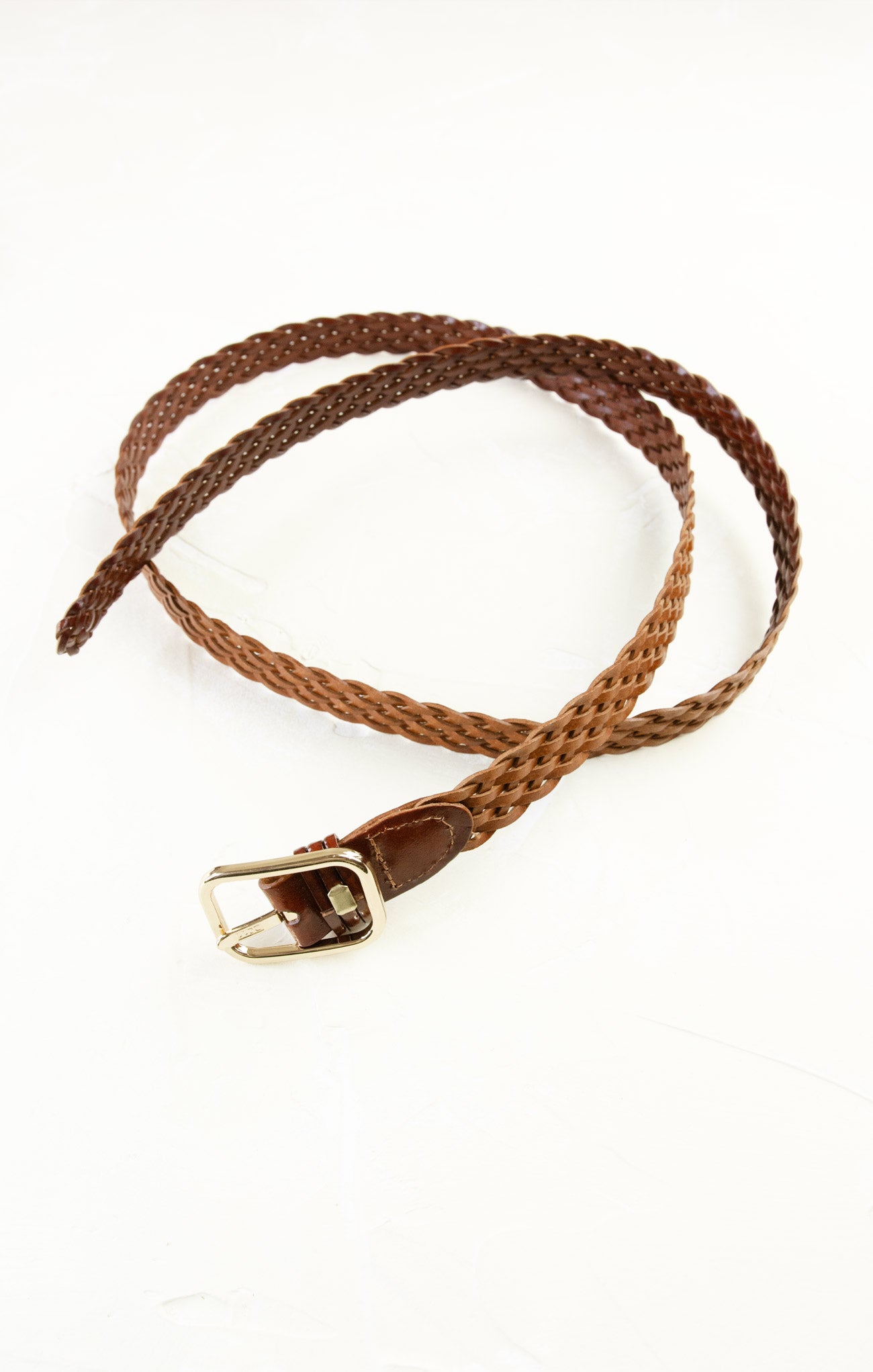 Brown braided belt with a gold buckle on a white background