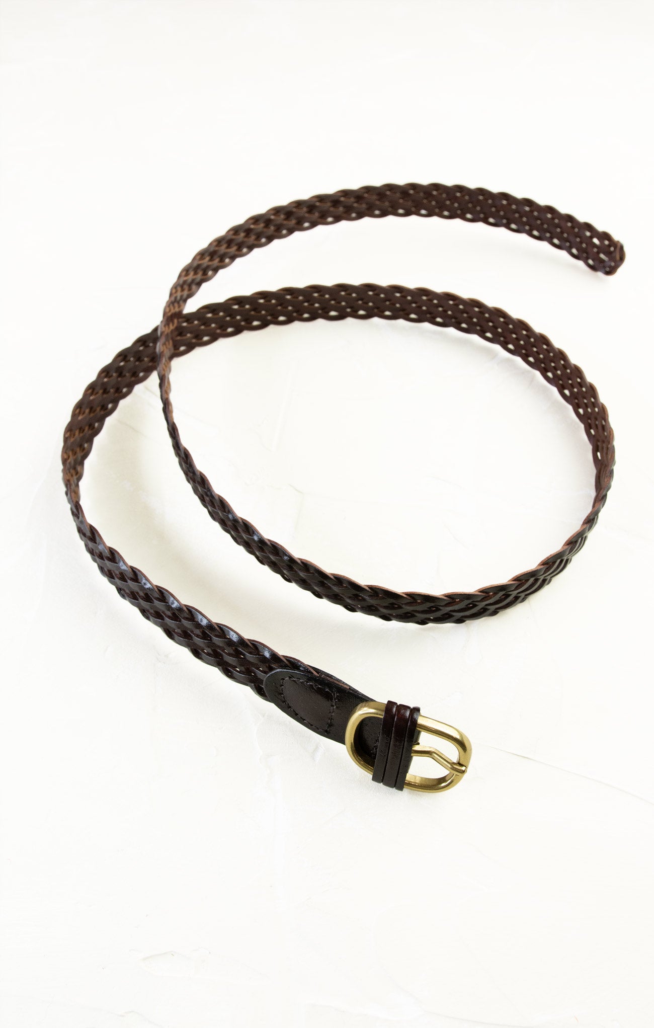 Brown braided belt with a gold buckle on a white background