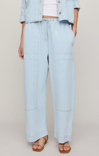 Light blue striped pants worn by a person on a plain background