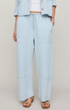 Light blue striped pants worn by a person on a plain background