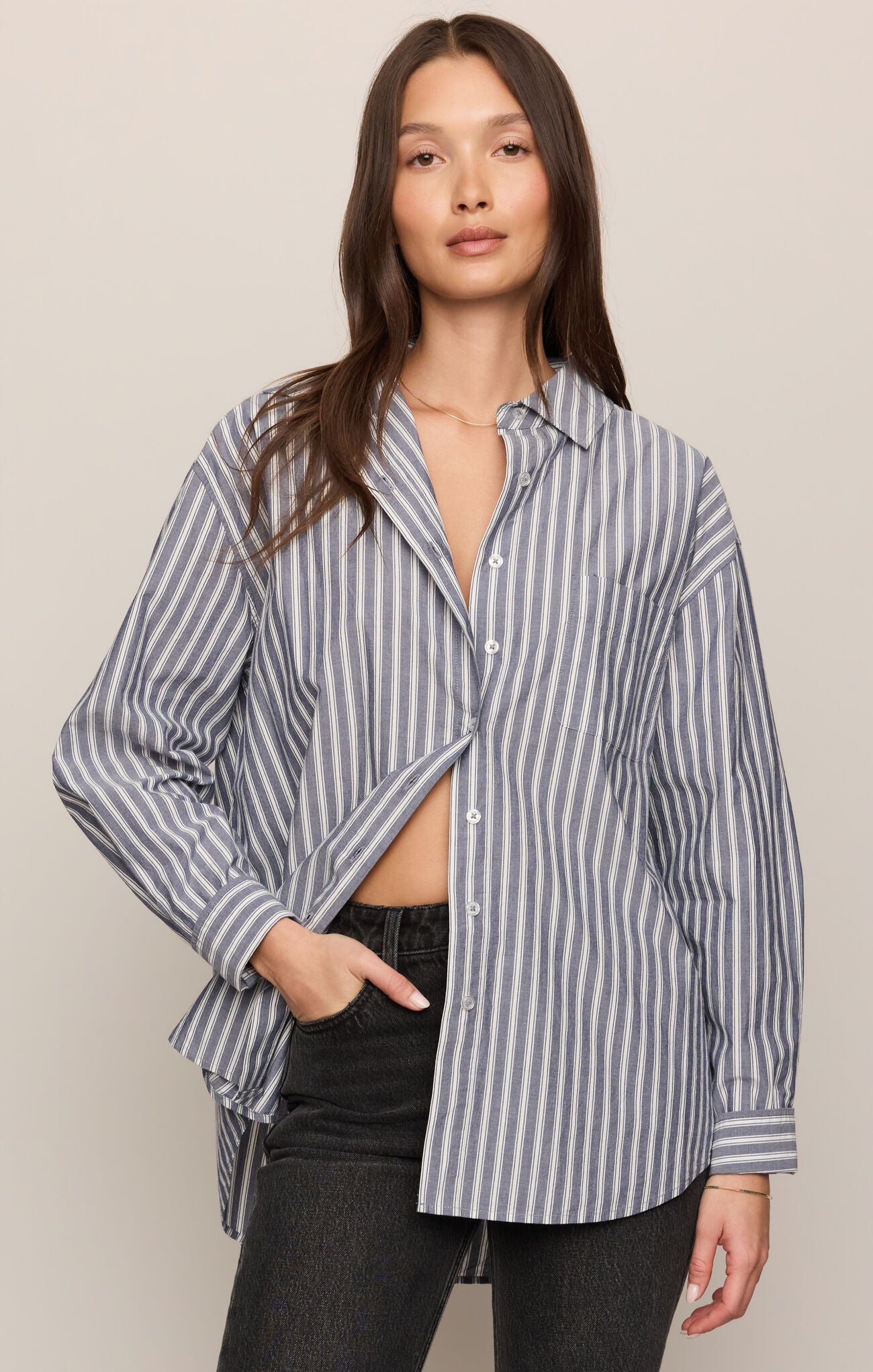 Woman wearing a striped shirt with a beige background