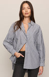 Woman wearing a striped shirt with a beige background
