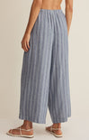 Blue striped wide-leg pants worn by a person on a beige background
