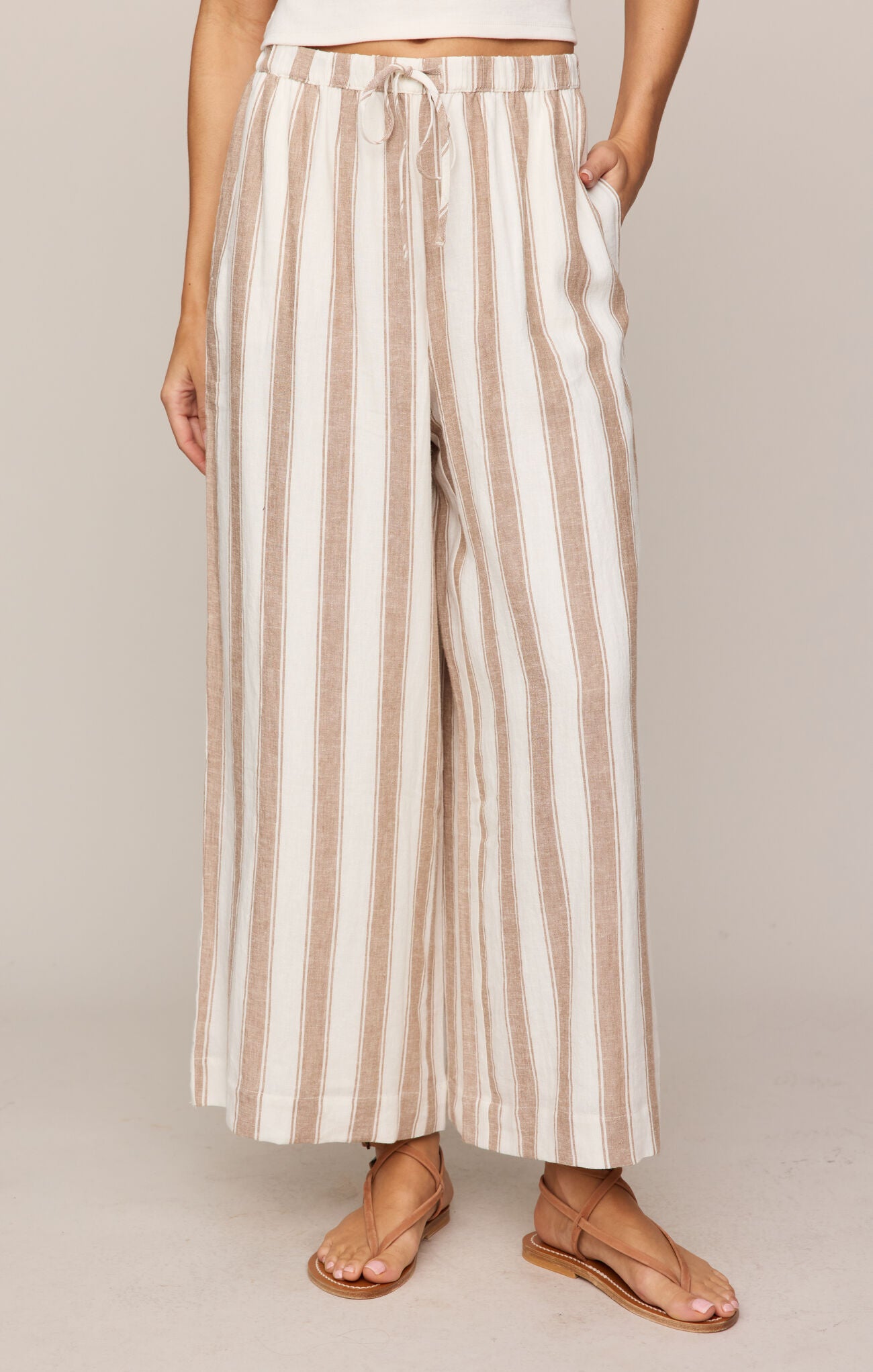 Striped pants worn by a person on a plain background