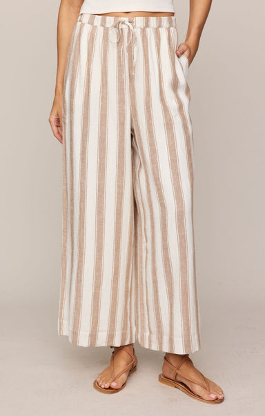 Striped pants worn by a person on a plain background