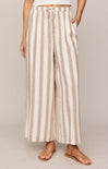 Striped pants worn by a person on a plain background