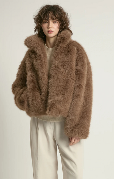 Person wearing a brown fluffy jacket on a white background
