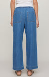 Person wearing blue denim pants on a plain background
