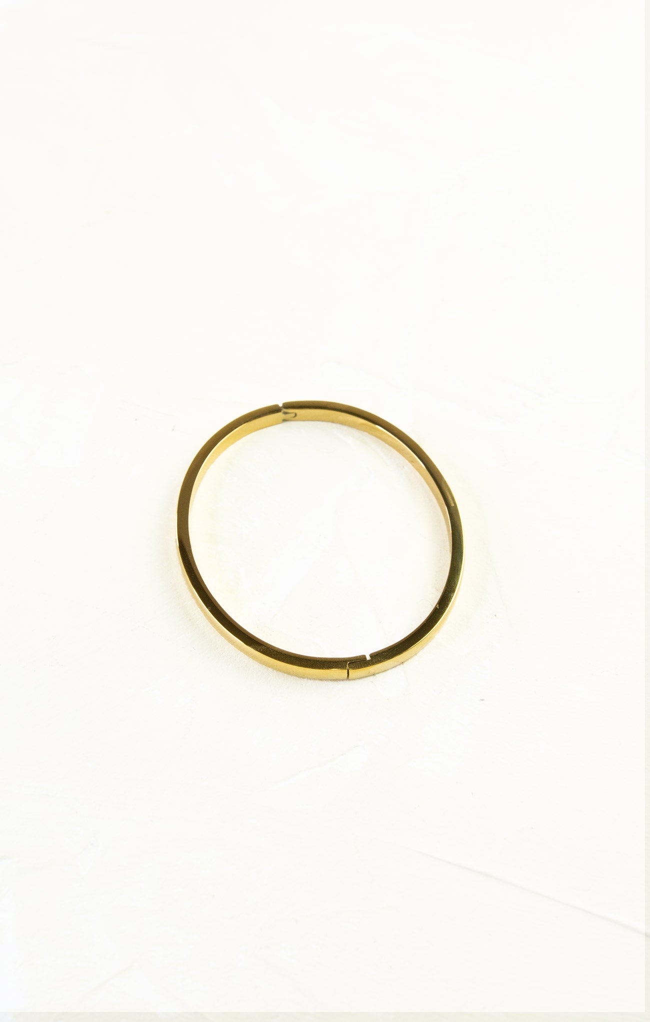 Gold hoop earring on a white background