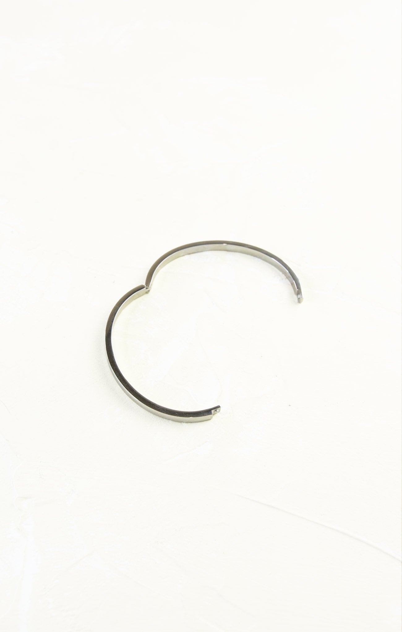 Silver hoop earring on a white background