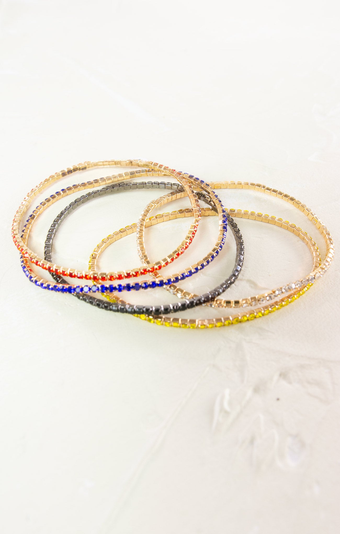 Set of colorful beaded bracelets on a light background