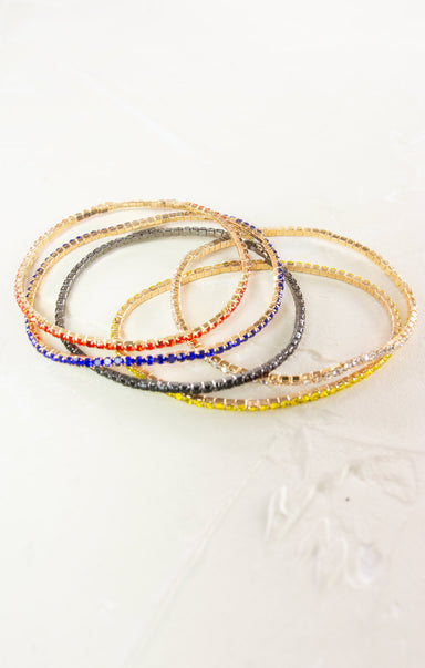 Set of colorful beaded bracelets on a light background