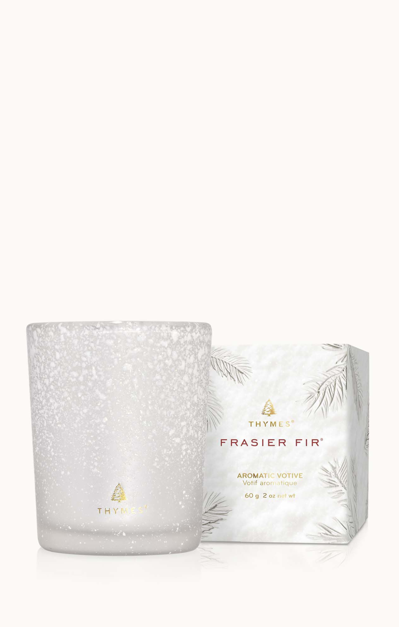 White speckled candle with Thymes Frasier Fir packaging on a white background