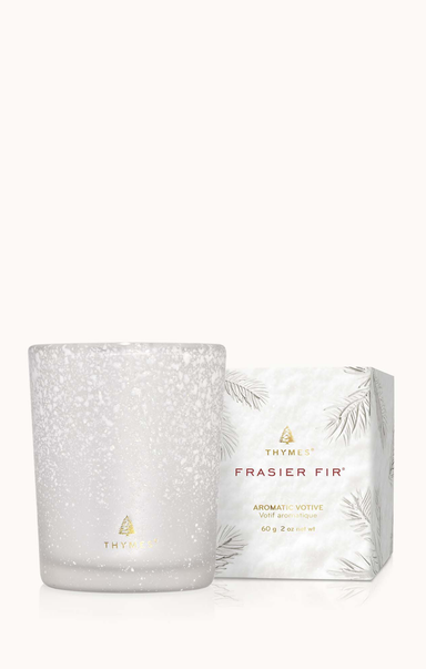 White speckled candle with Thymes Frasier Fir packaging on a white background