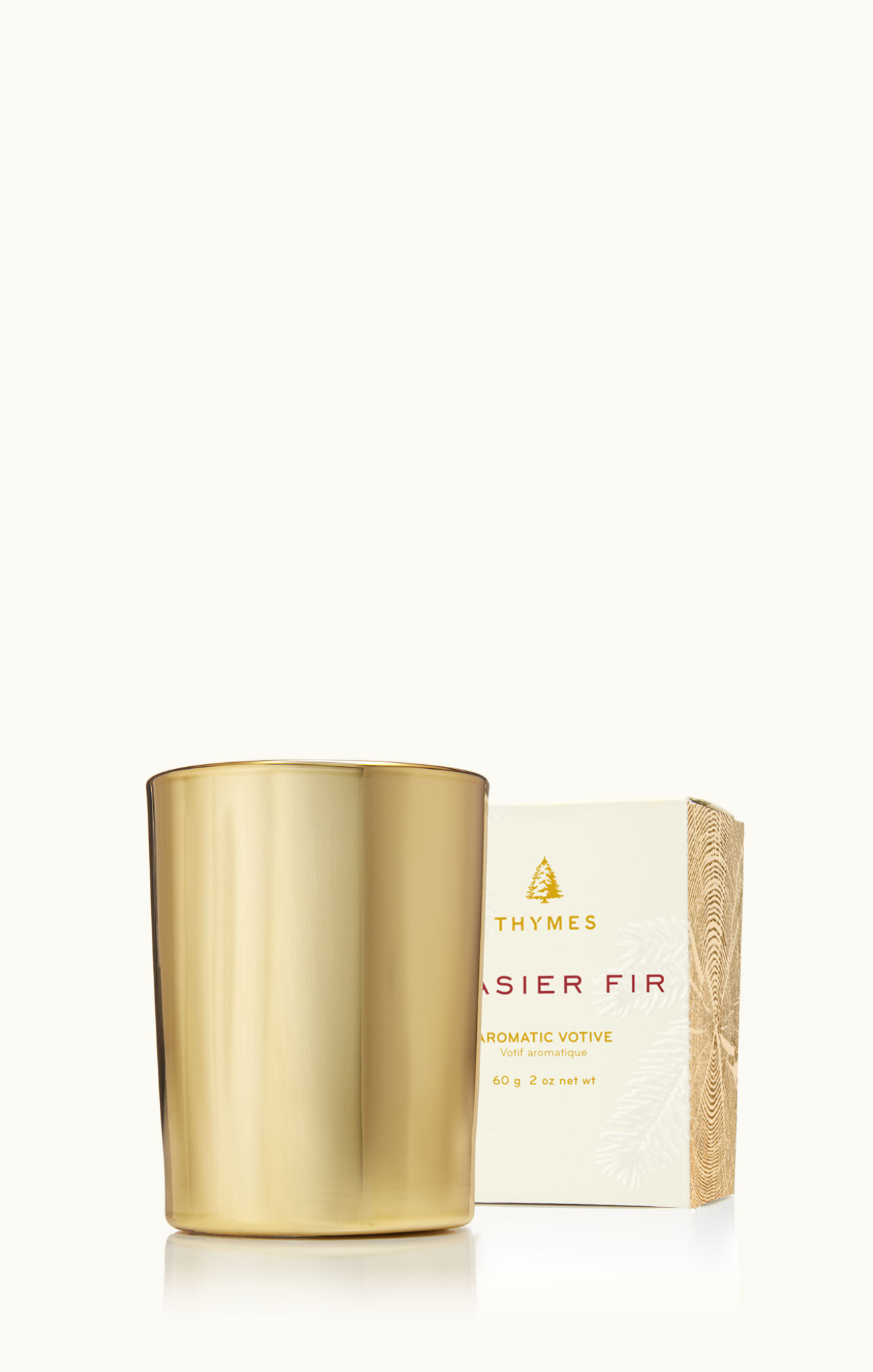 Gold candle and white packaging with 'Thymes' branding on a white background