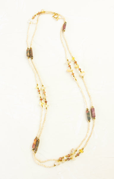 Necklace with multicolored beads on a white background
