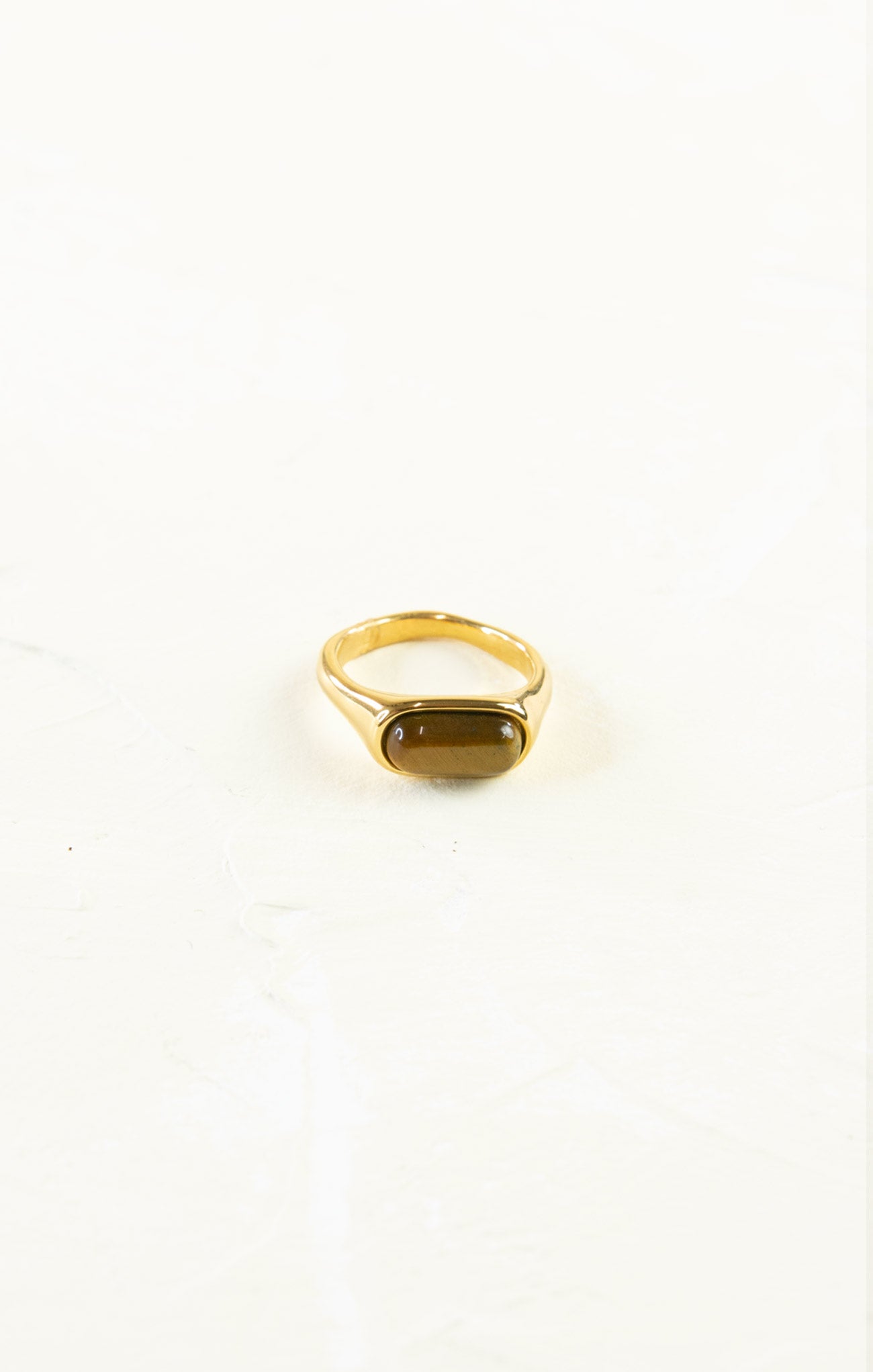 Gold ring with a gemstone on a white background