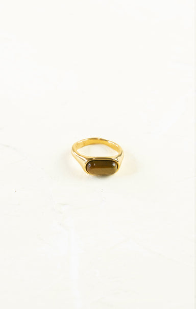 Gold ring with a gemstone on a white background