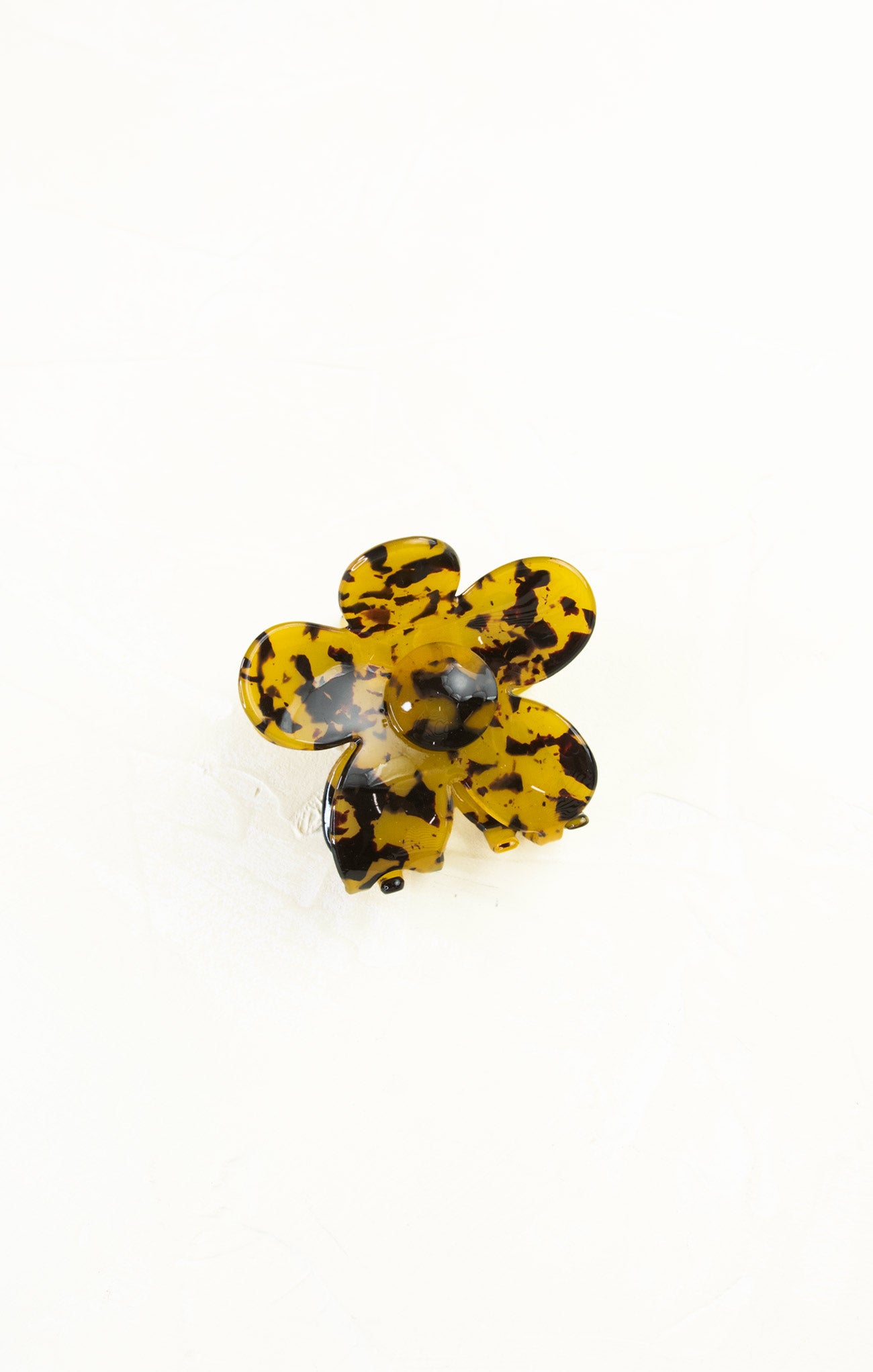 Flower-shaped object with black and yellow pattern on a white background