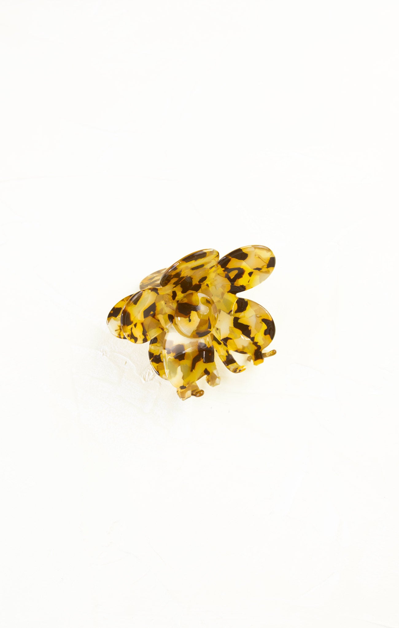 Yellow tortoiseshell ring on a white background