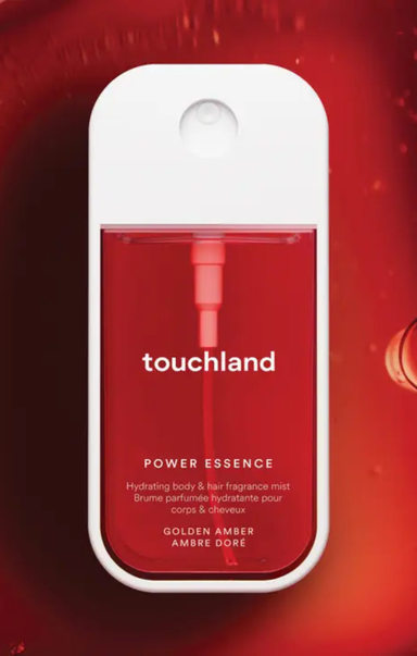 Touchland Power Essence bottle on a red background