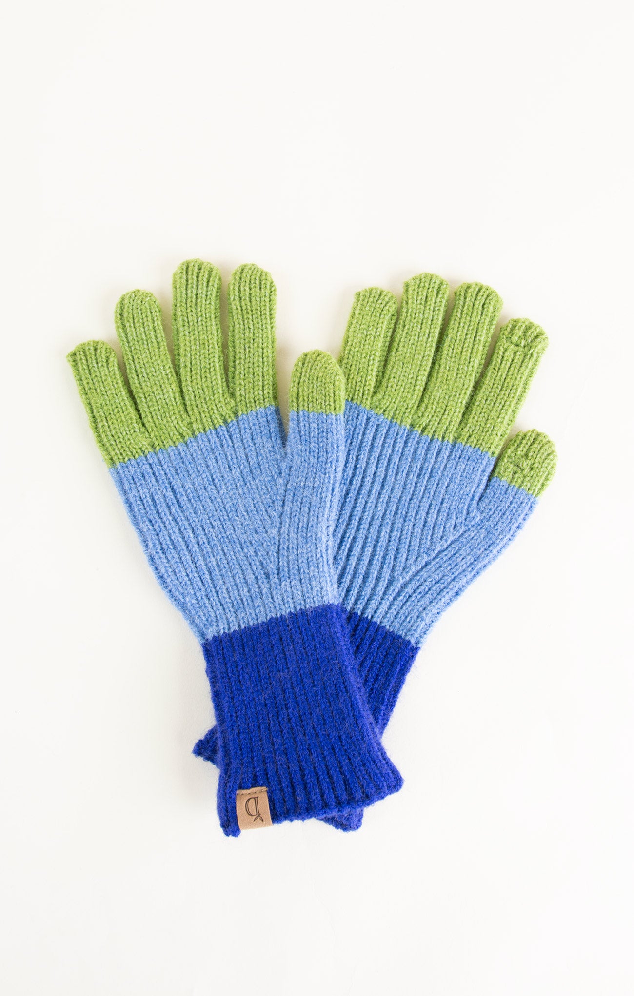Pair of gloves with blue and green color block design on a white background