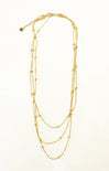 Gold necklace with multiple layers on a white background