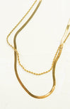 Two gold necklaces on a white background