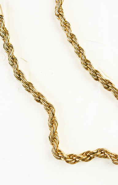 Gold rope chain necklace on a white background
