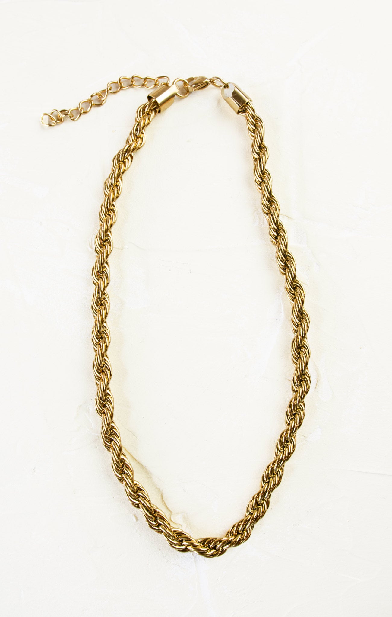 Gold chain necklace on a white background
