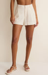 Person wearing white shorts on a plain background