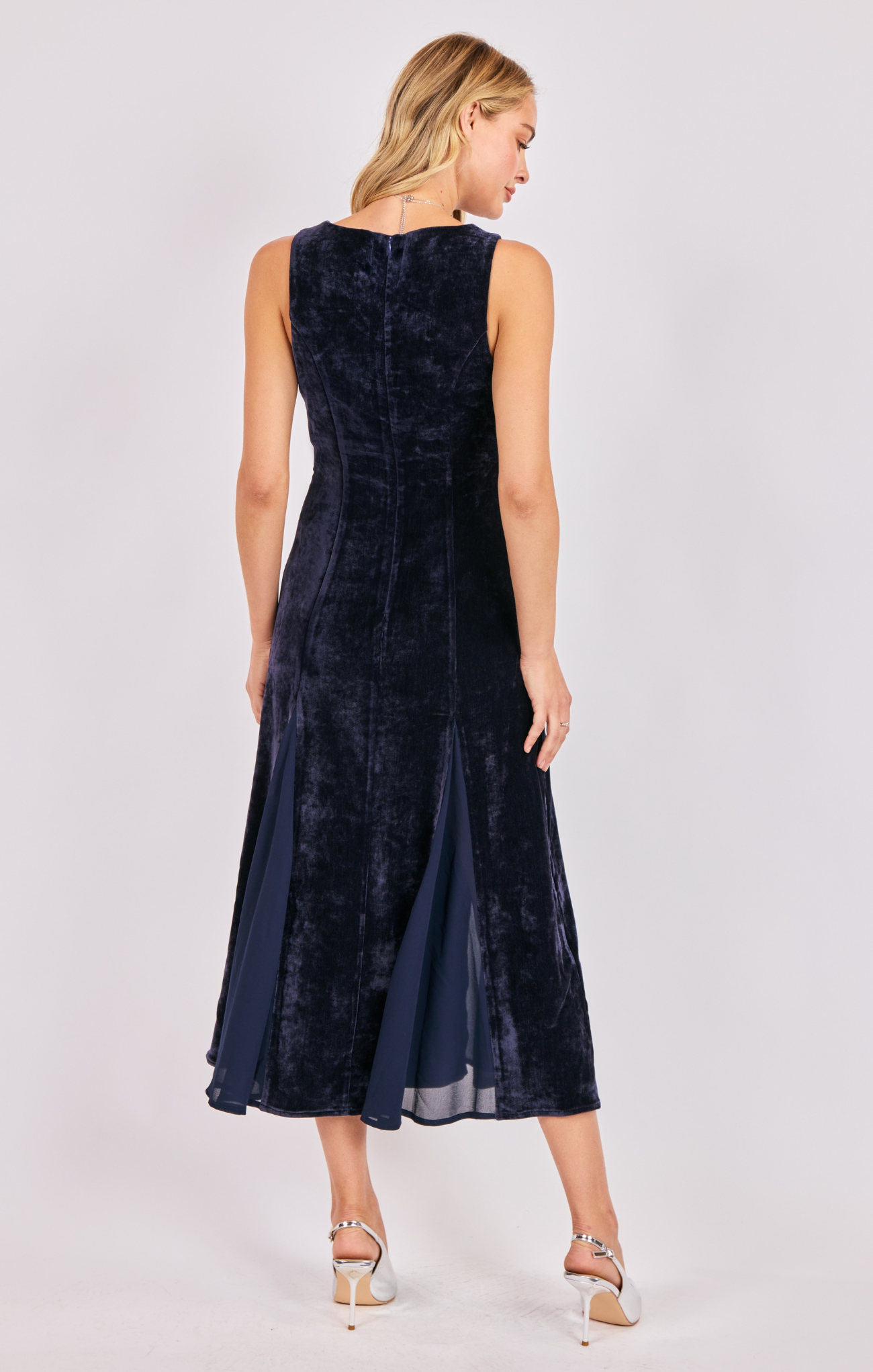 Woman wearing a navy blue dress on a white background