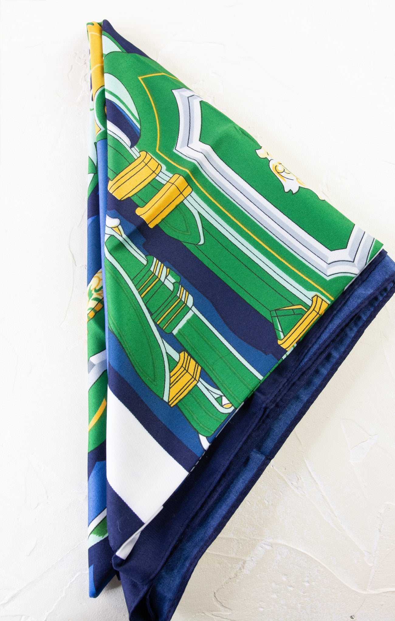 Folded fabric with green and blue pattern on a white background