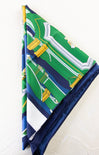 Folded fabric with green and blue pattern on a white background