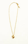Gold necklace with a heart-shaped pendant on a white background