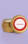 Gold candle jar with 'capri BLUE Volcano' label on a purple background
