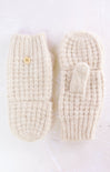 Pair of cream-colored knitted mittens on a white background