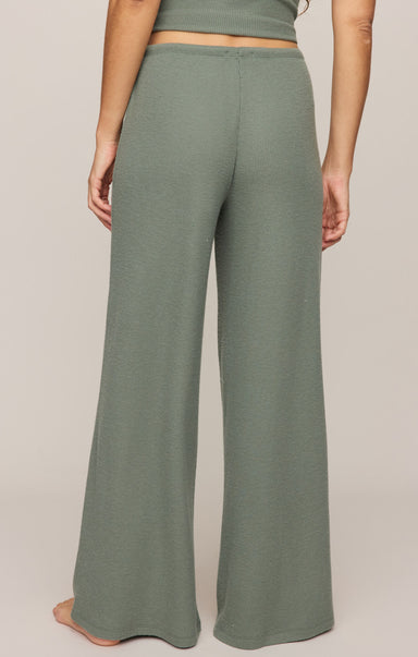 Green wide-leg pants worn by a person on a plain background
