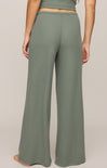 Green wide-leg pants worn by a person on a plain background