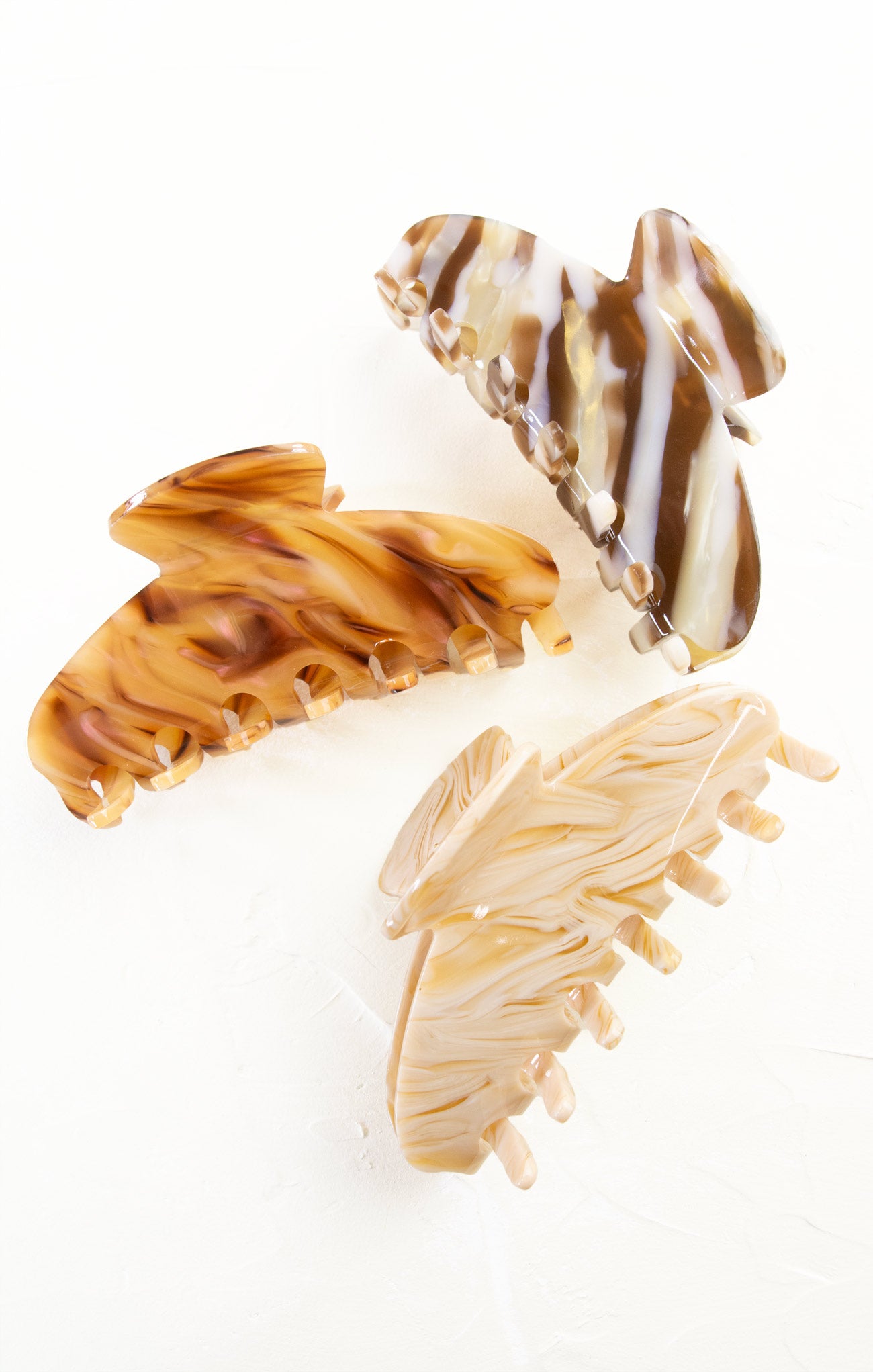 Three tortoiseshell-patterned hair clips on a white background