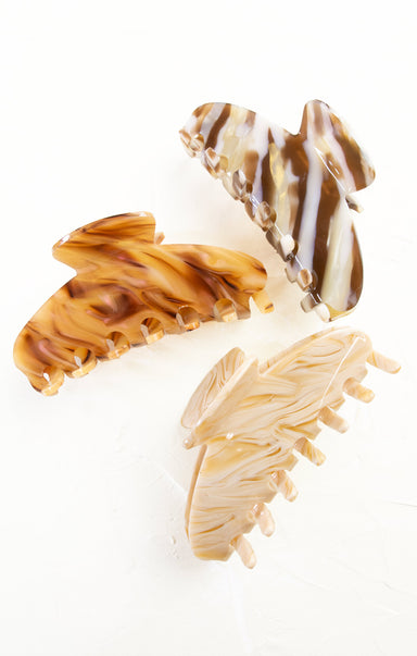 Three tortoiseshell-patterned hair clips on a white background