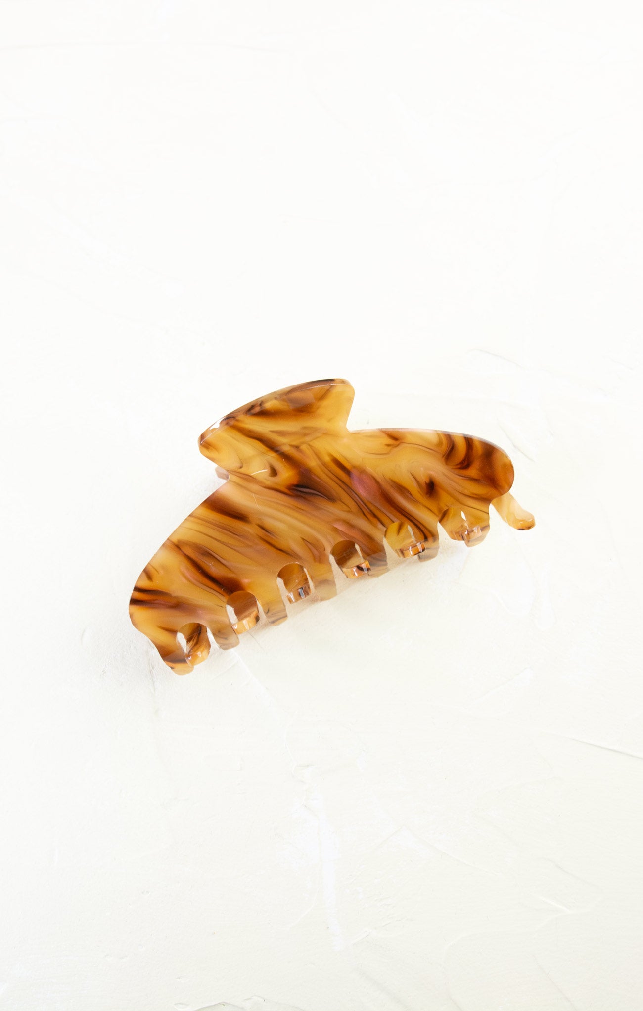 Tortoiseshell hair comb on a white background