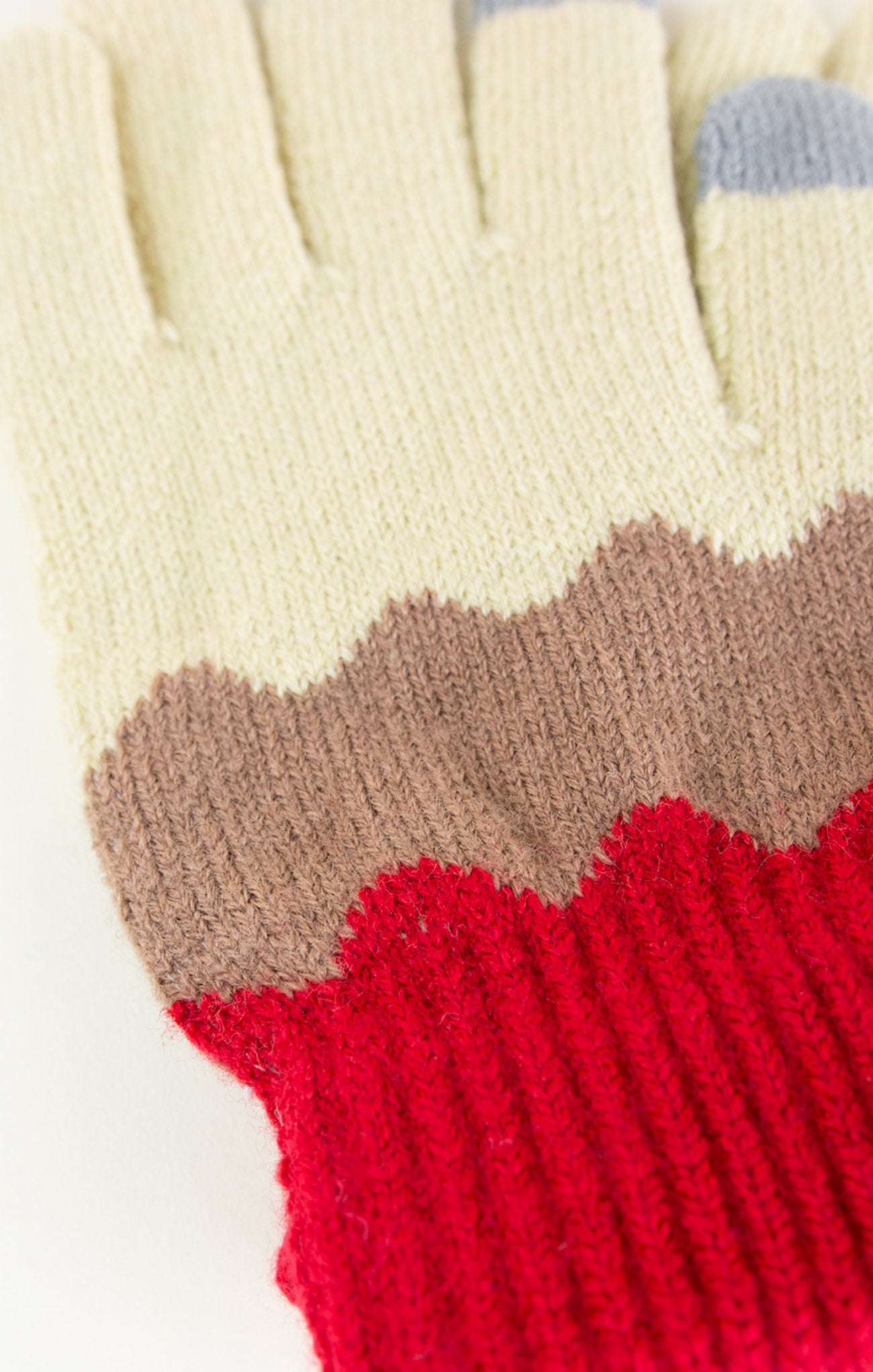 Close-up of a multicolored glove with beige, brown, and red sections.