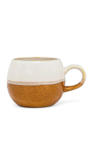 A ceramic mug with a two-tone finish, featuring a textured warm brown lower half and a smooth off-white upper half, with a matching off-white handle and rim.