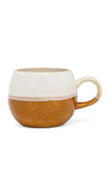 A ceramic mug with a two-tone finish, featuring a textured warm brown lower half and a smooth off-white upper half, with a matching off-white handle and rim.