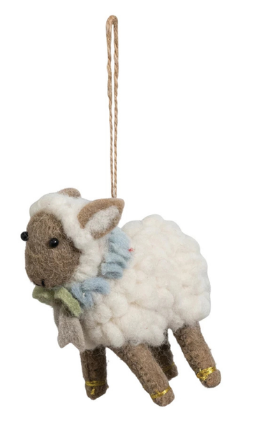 Decorative sheep ornament with a blue scarf on a white background