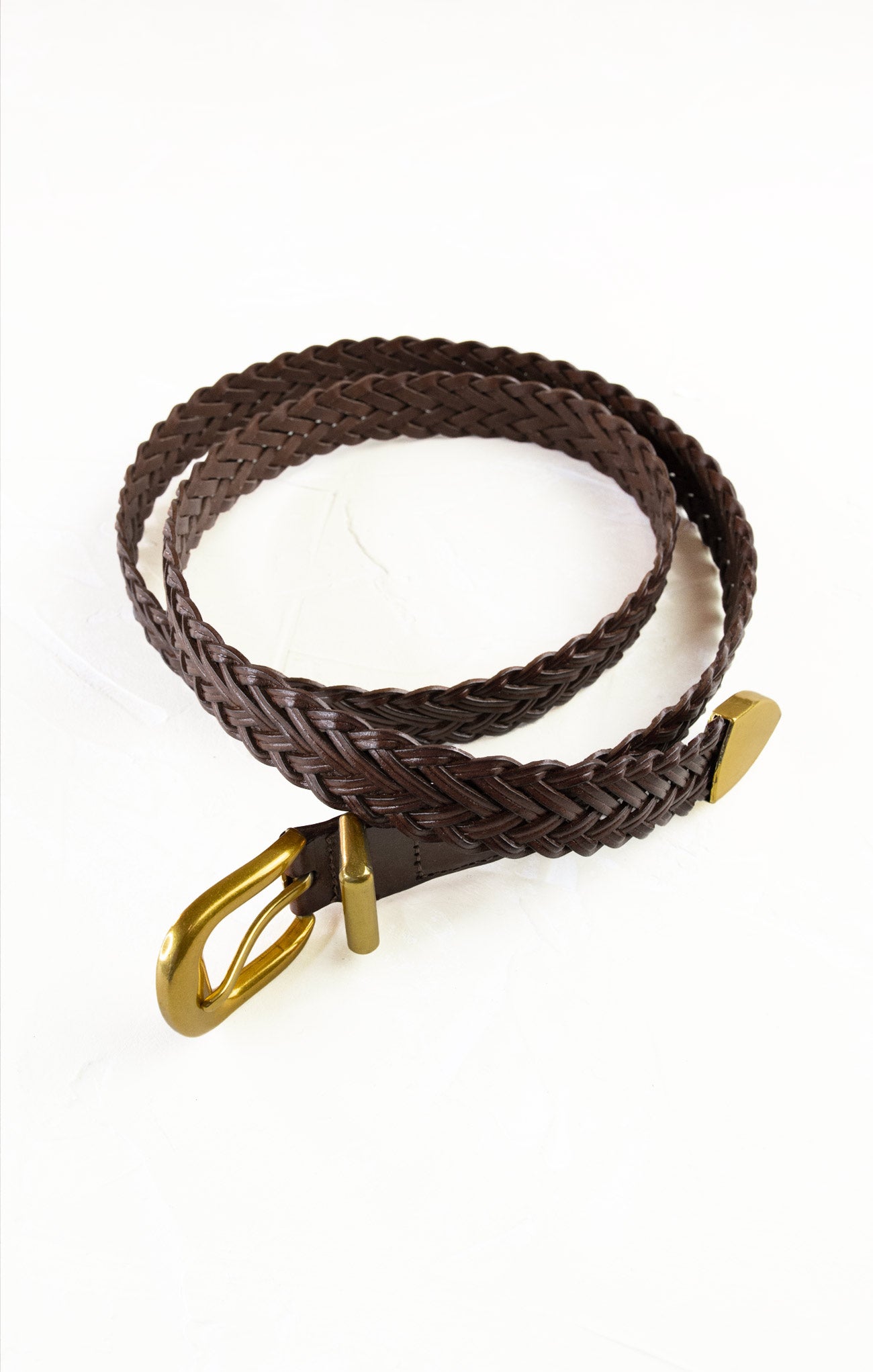 Brown braided belt with a gold buckle on a white background