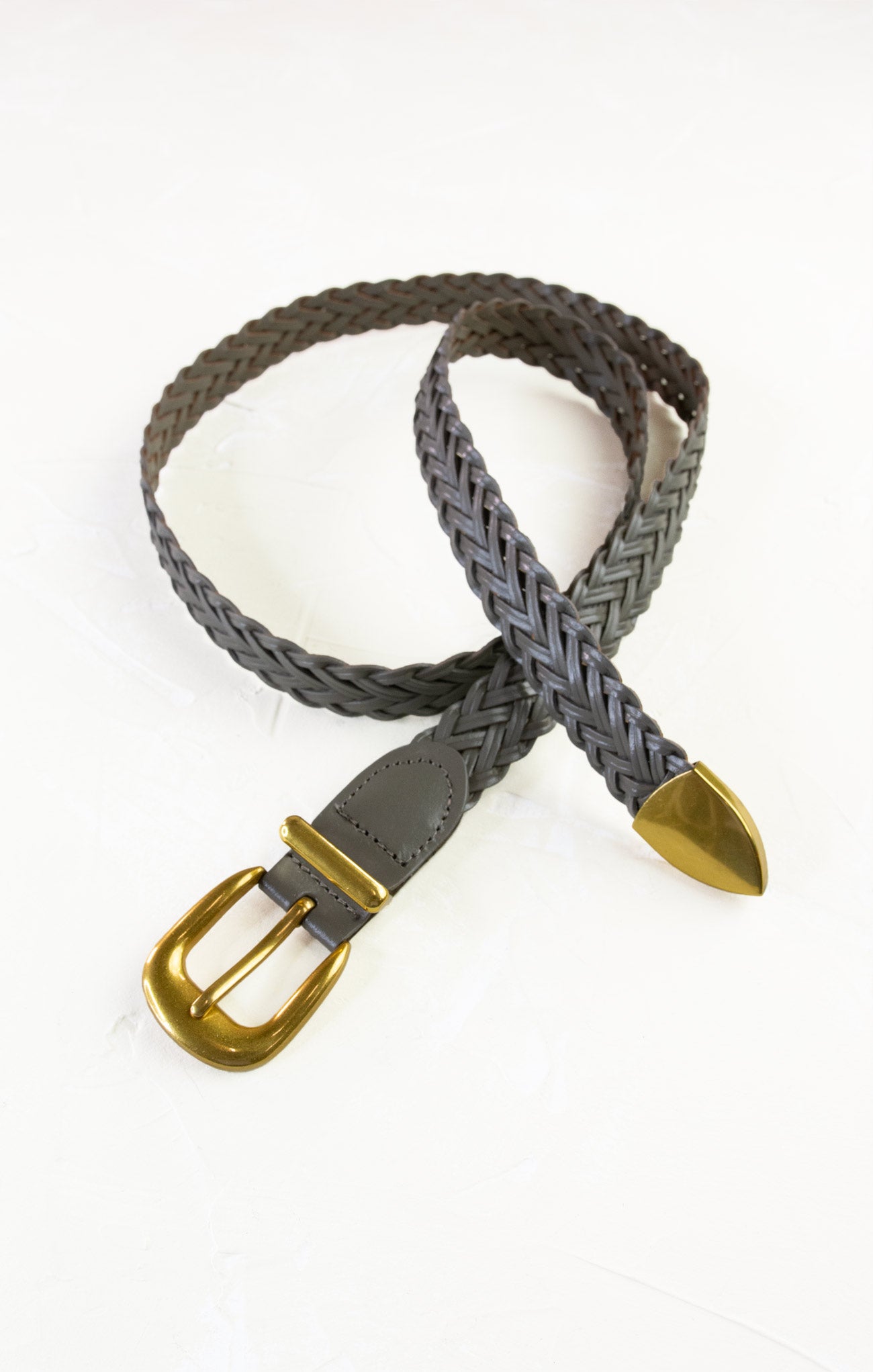 Gray braided belt with a gold buckle on a white background